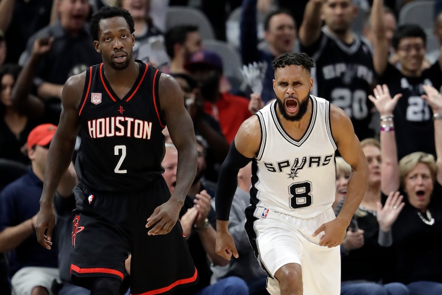 San Antonio Spurs' Patty Mills (8) celebrates a basket against Houston's Patrick Beverley in 2017.