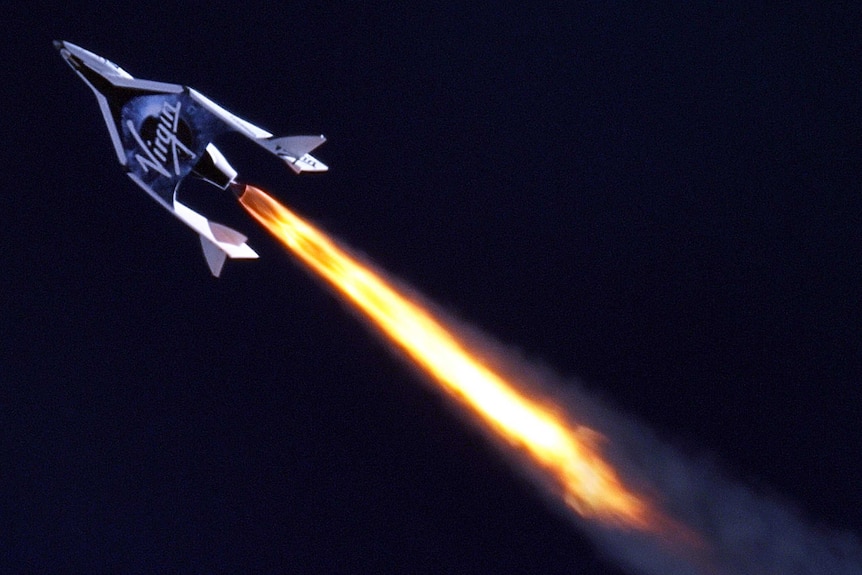 SpaceShip2 under rocket power at high altitude.