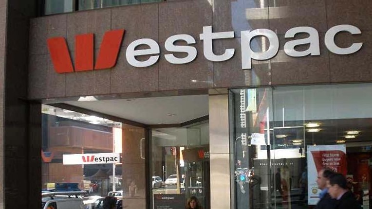 People walk past a Westpac branch