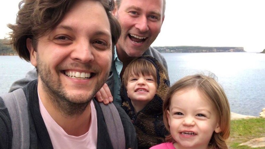 Sean Szeps, pictured with his husband Josh (centre) and two children.