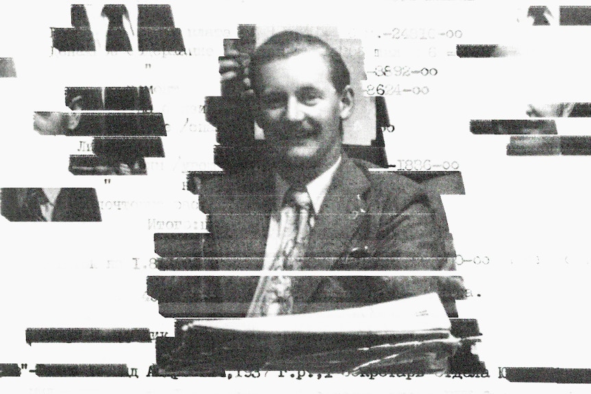 A black and white photo of a smiling man in a suit and tie. Other faces around him have been stylistically redacted.