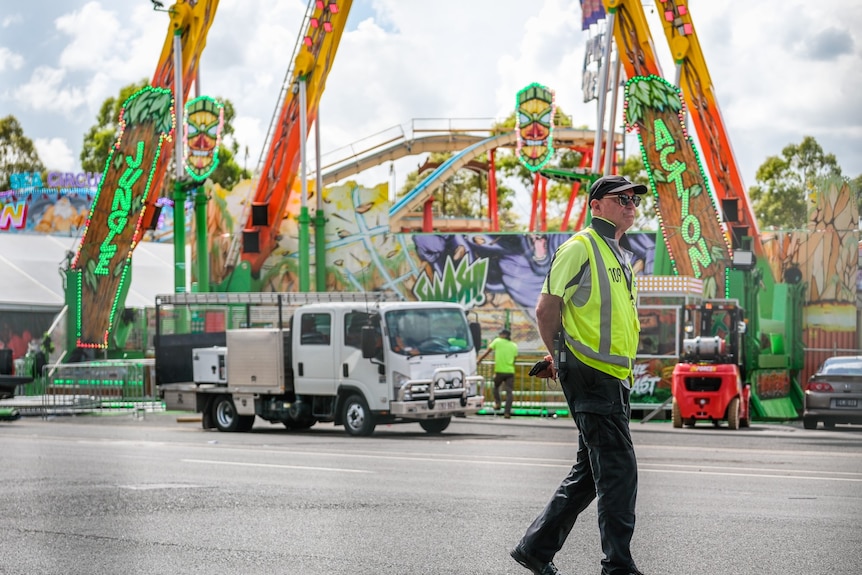 Worker walking near a festival ride