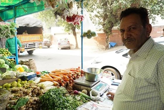 Vegetable seller Shayam Singh stands in his street vegetable shop