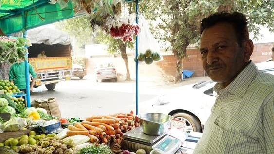Vegetable seller Shayam Singh stands in his street vegetable shop