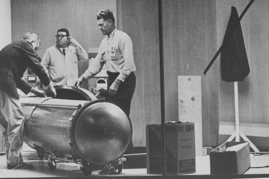 Archival image of Hope Edward and a cryocapsule designed to preserve a frozen corpse, 1967.