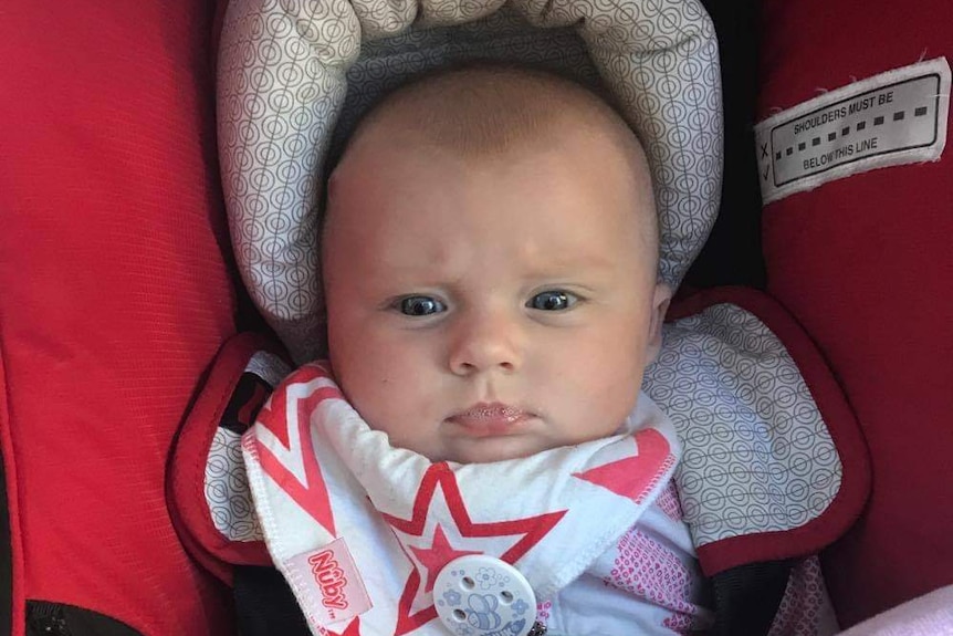 Baby Darcey in car seat.