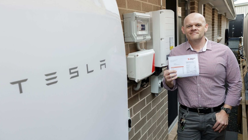 Nick Pfitzner with his Tesla Powerwall home battery