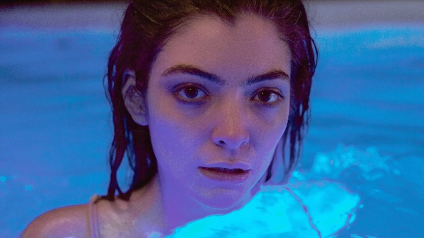 Lorde emerging from a pool