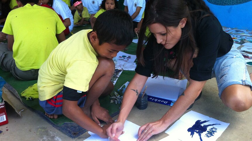 Tara Winkler with a Cambodian child