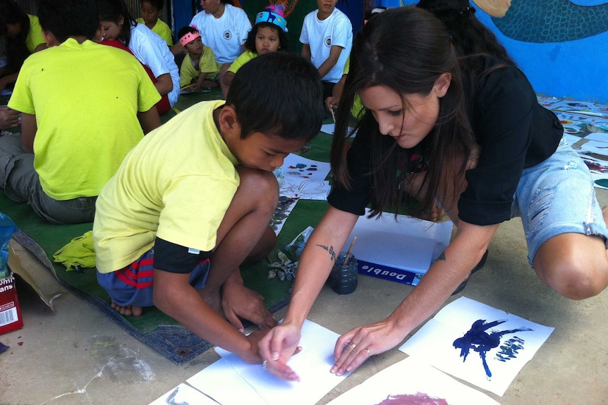 Tara Winkler with a Cambodian child