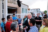 Donald Trump talks with local residents during a walking tour of areas damaged by Hurricane Maria.