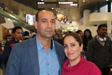 Travellers Rasool Zareie and Shirin Salimbayat hug and look at the camera