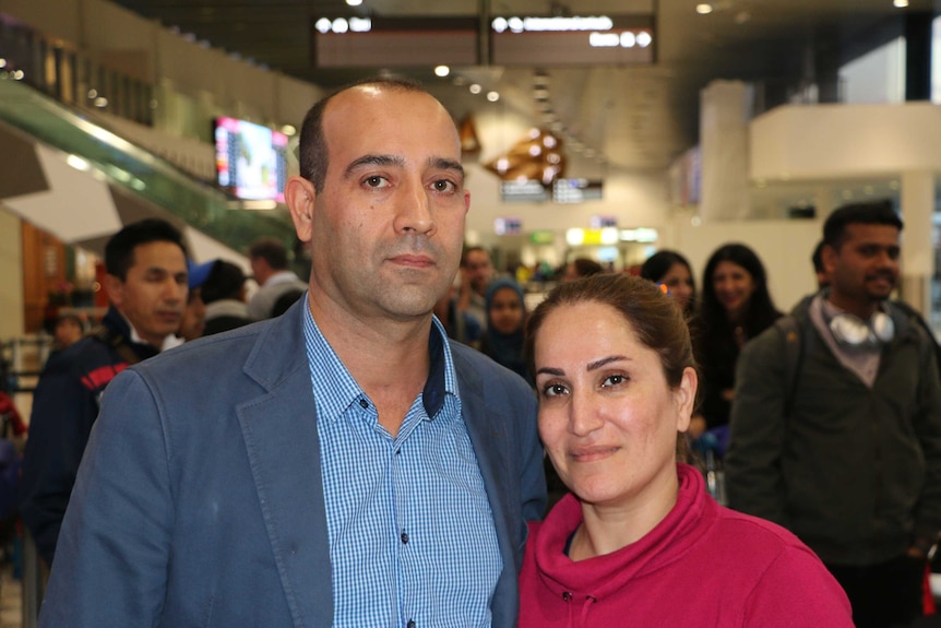 Travellers Rasool Zareie and Shirin Salimbayat hug and look at the camera