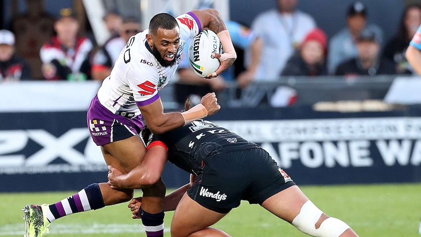 Josh Addo-Carr is tackled by Isaiah Papali'i of the Warriors