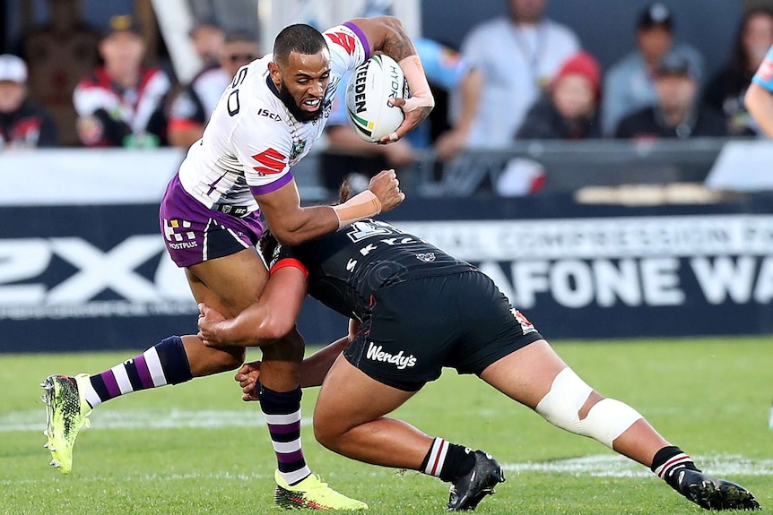 Josh Addo-Carr is tackled by Isaiah Papali'i of the Warriors