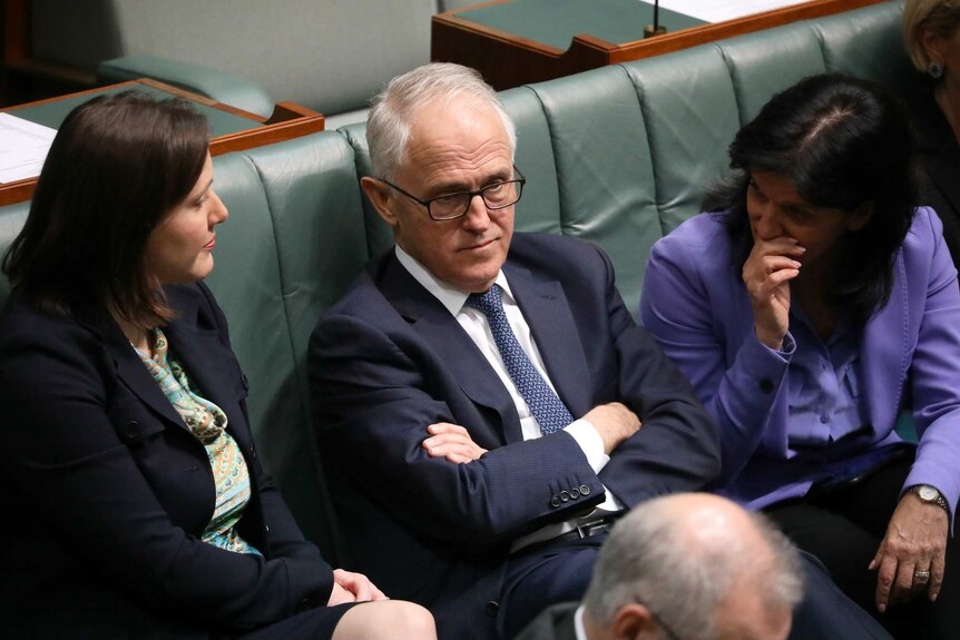Julia Banks whispers to Malcolm Turnbull, while Kelly O'Dwyer listens in