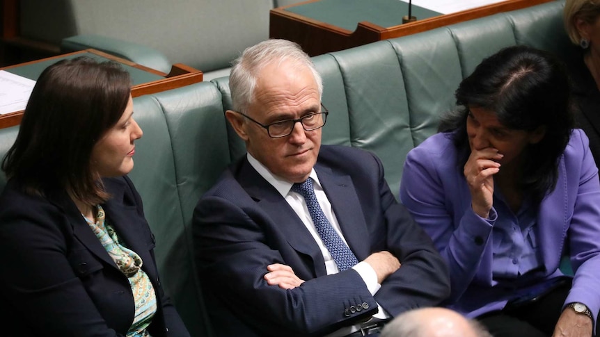 Julia Banks whispers to Malcolm Turnbull, while Kelly O'Dwyer listens in