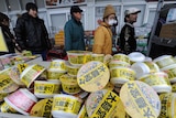Food contaminated: People queue for food at a supermarket in Ishinomaki