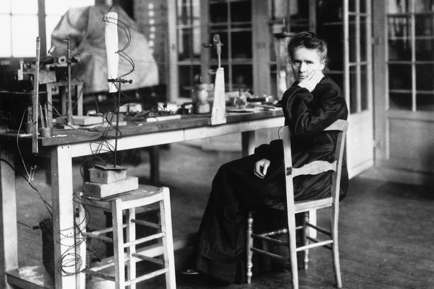 Black and white photo of Marie Curie in her laboratory.