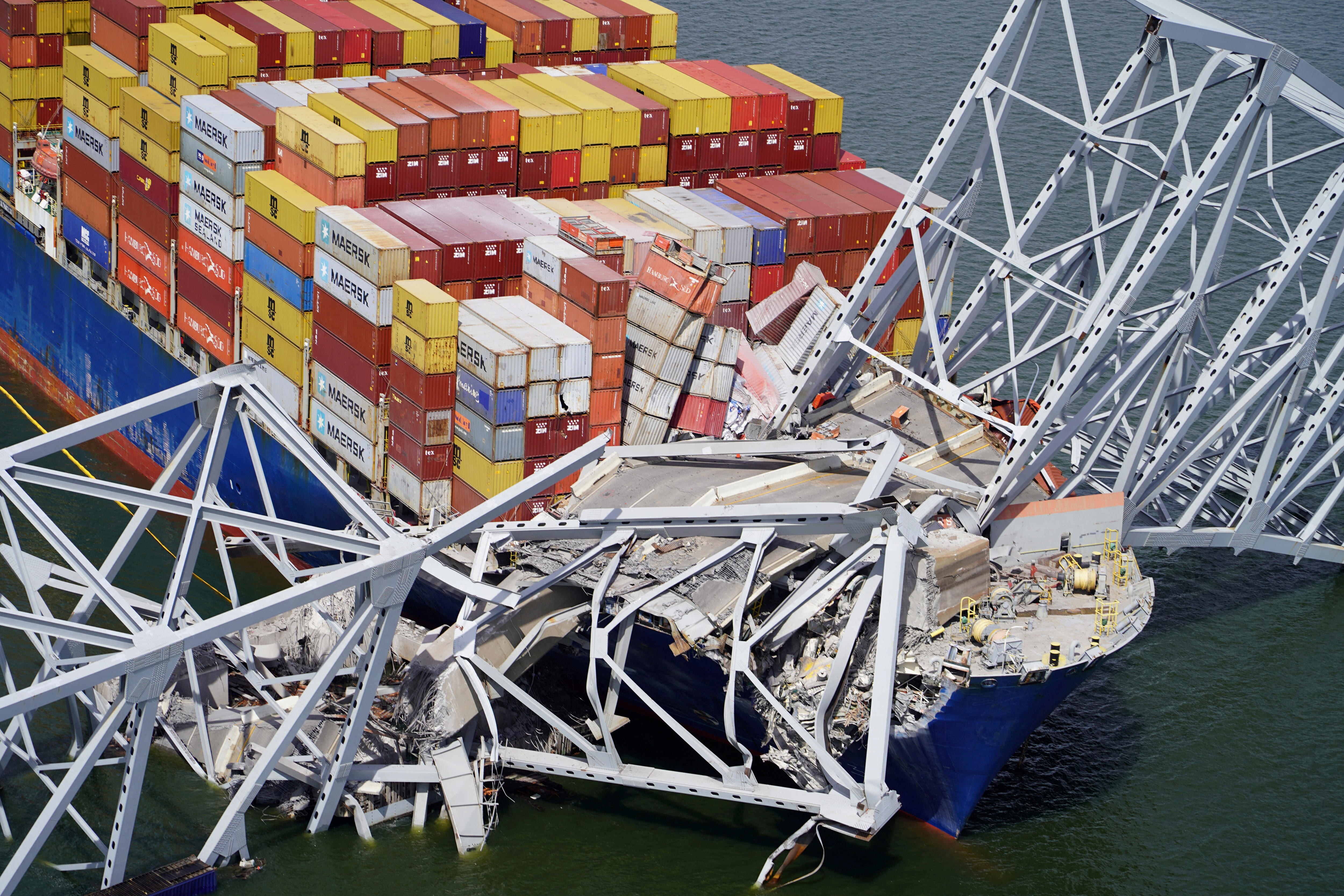 A close up view of the front of a cargo ship with metal beams and broken concrete on top