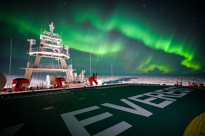 A green aurora australis seen above the deck of an Antarctic icebreaker.