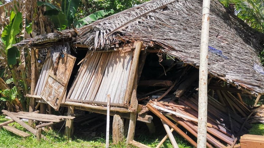 A collapsed house and leaning to one side shown at Chambri Lake.