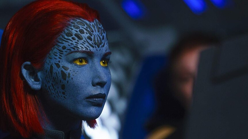 Mystique with blue face and red hair and yellow eyes