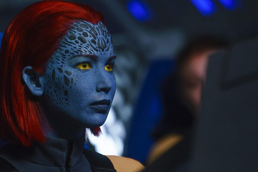 Mystique with blue face and red hair and yellow eyes
