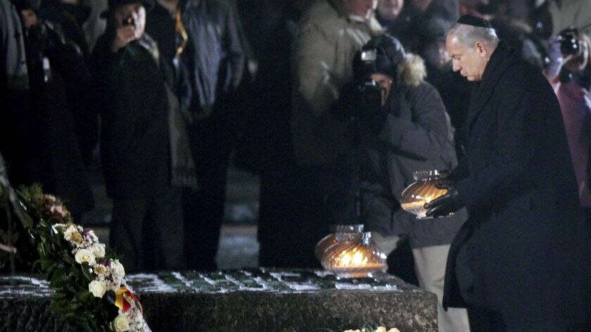 Israel's Prime Minister Benjamin Netanyahu places a candle at a memorial Auschwitz Birkenau