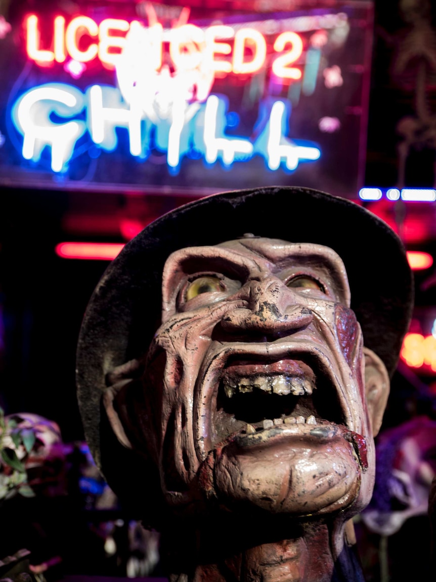 A model of Freddy Krueger snarls outside a ride at the show.