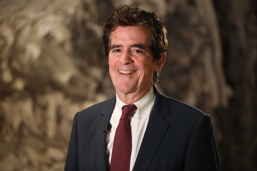 Head and shoulders portrait of man in suit and tie.