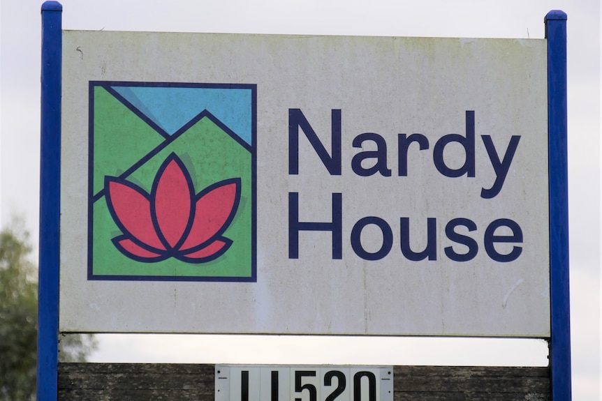 A sign with a colourful stylised logo and the text "Nardy House".