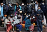 Relatives wait to create a man killed by Nepal quake