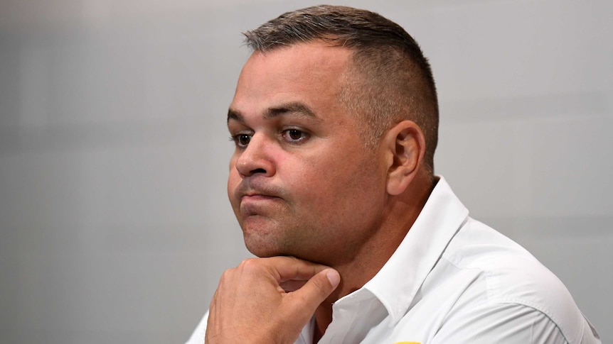 Anthony Seibold holds his hand under his chin and purses his lips