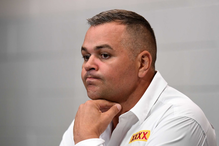 Anthony Seibold holds his hand under his chin and purses his lips