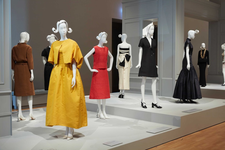 Mannequins wearing Christian Dior dresses as part of an NGV exhibition.