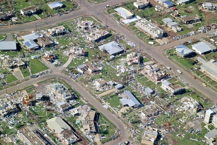 An aerial photo showing streets of razed houses.