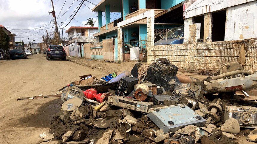 A pile of rubble and destroyed furniture on a street in Puerto Rico after a hurricane ripped through.