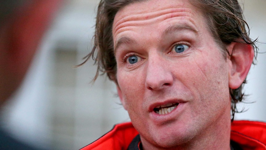 Essendon coach James Hird speaks to the media outside his home in Toorak.