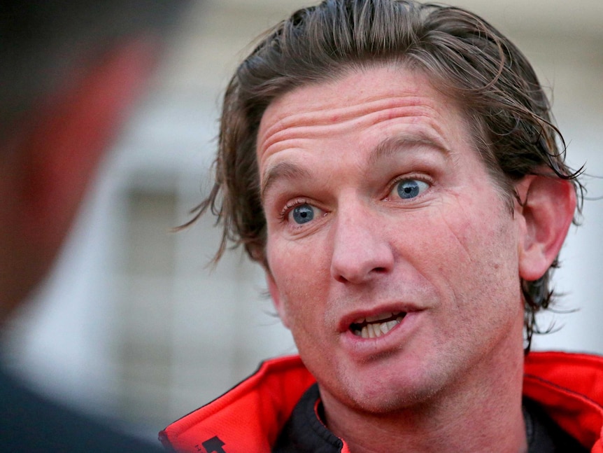 Essendon coach James Hird speaks to the media outside his home in Toorak.