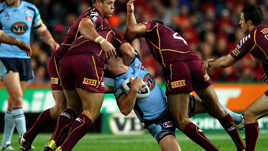 Greg Bird of the Blues is tackled during game two of the ARL State of Origin series