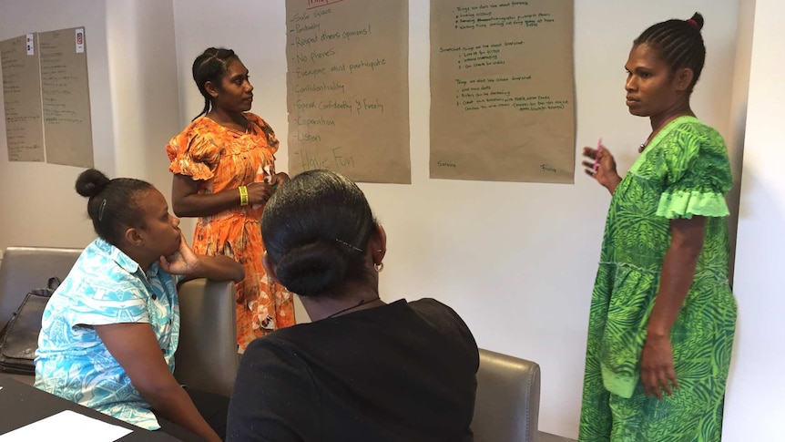 Four women brainstorming together