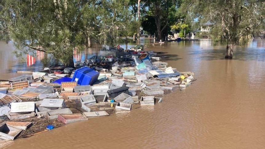 a group of beehives submerged in flood waters