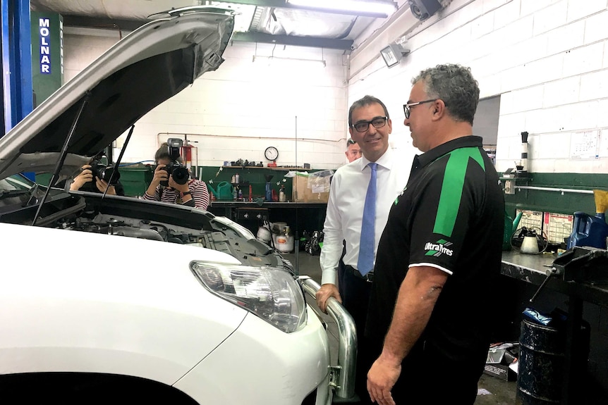 SA Liberal leader Steven Marshall inspects a car at an Unley workshop.