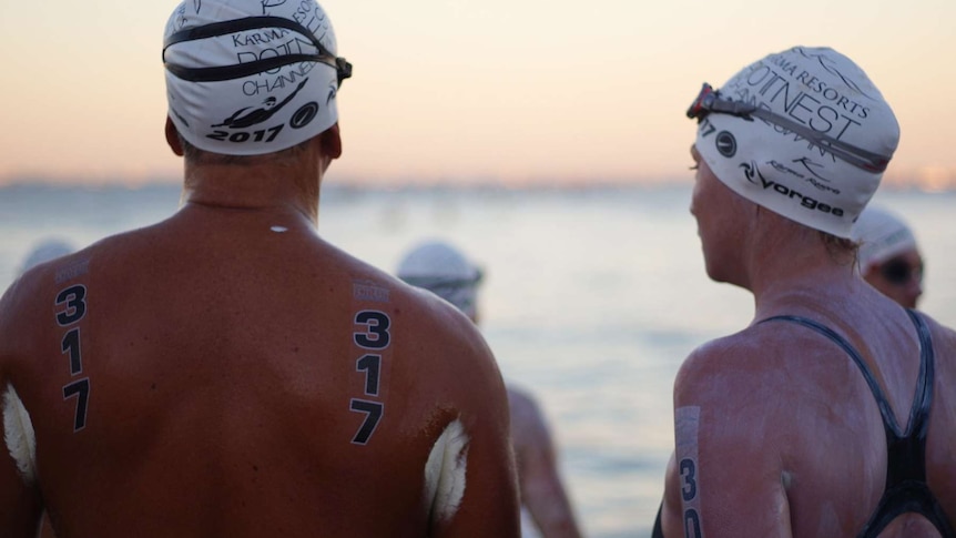Two competitors look out to sea ahead of the swim.