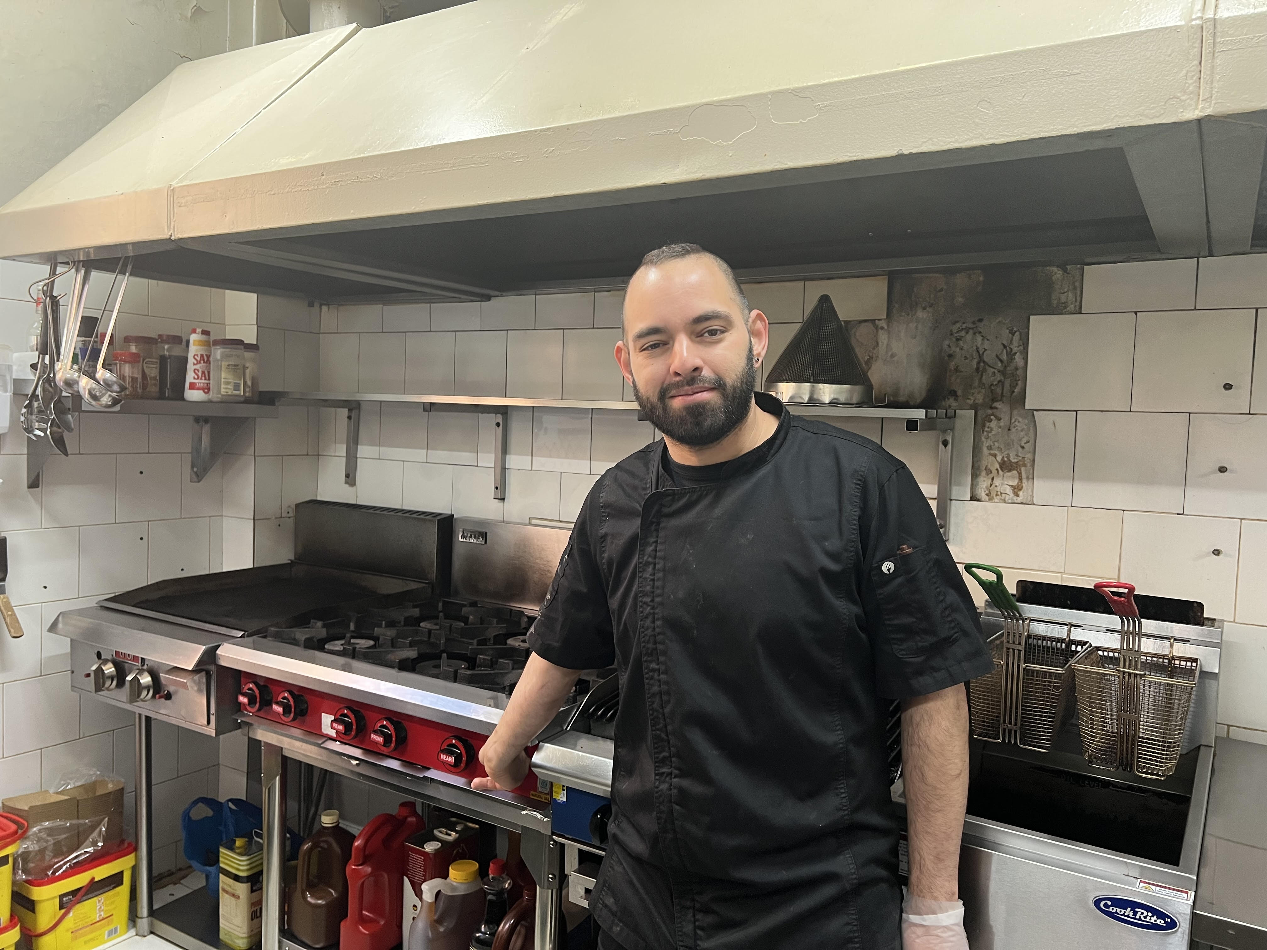 Head chef, Daniel Amador stands in his kitchen in front of the gas cook top that has been affected by the gas outage. 
