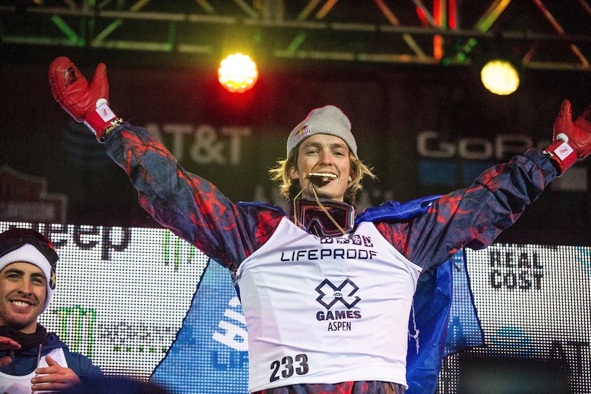 Australian snowboarder Scotty James (C), celebrates after Winter X-Games superpipe win in 2017.