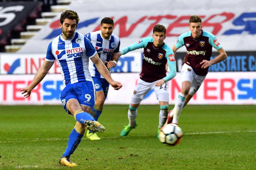 Wigan Athletic's Will Grigg scores from the penalty spot against West Ham.