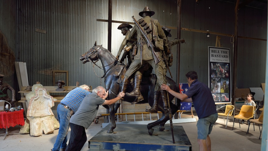 Play Audio. three men support a life sized bronze sculpture of a horse being ridden by soliders. Duration: 15 minutes 4 seconds