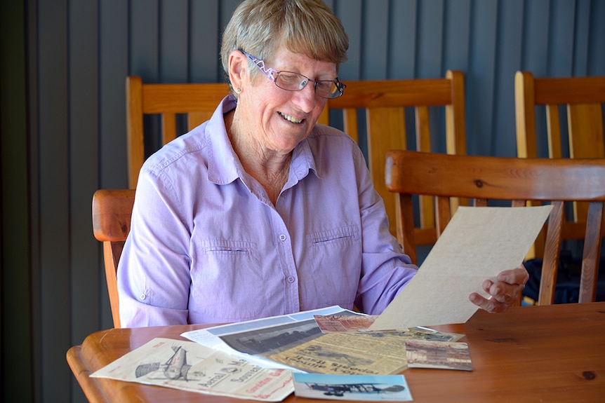 Lenore Thomas reads over the last letter written by her uncle Bob Fawcett.